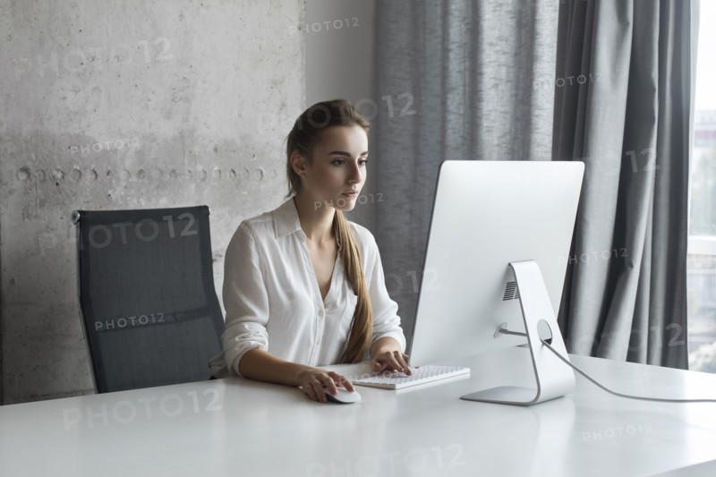 Young businesswoman working on desktop computer
