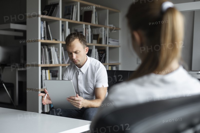Businessman conducting job interview with young woman