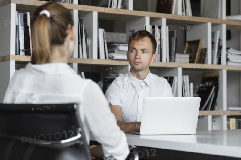 Businessman conducting job interview with young woman