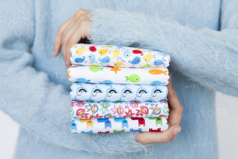 Hands of woman holding animal print fabrics