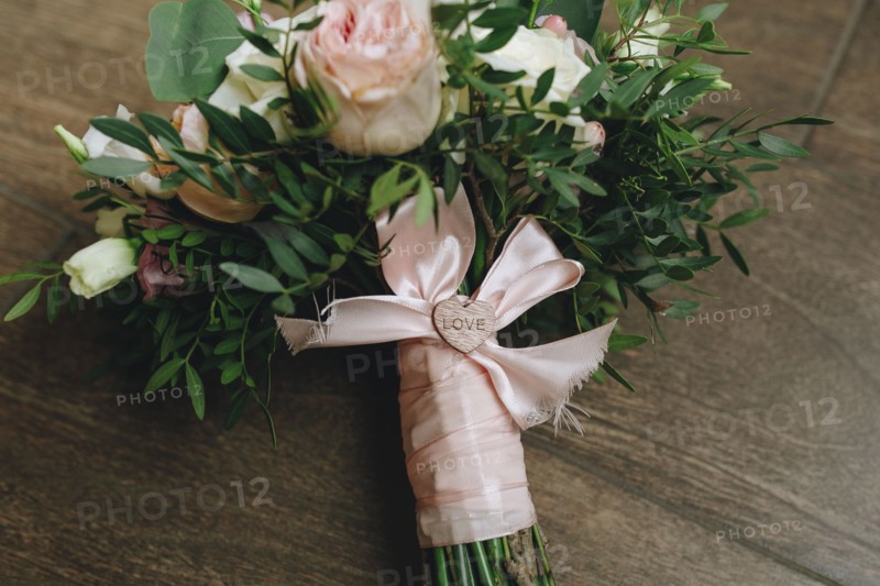 Wedding bouquet tied with pink ribbon