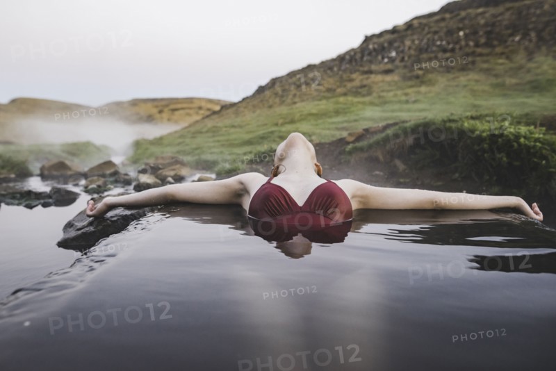 Woman bathing in hotpool in Iceland