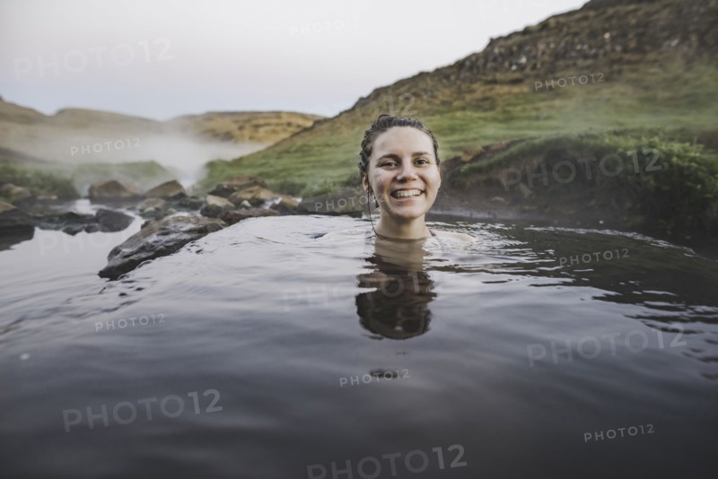 Woman bathing in hotpool in Iceland