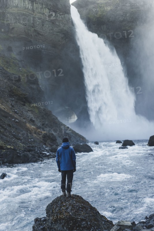 Hiker by Haifoss waterfall in Iceland