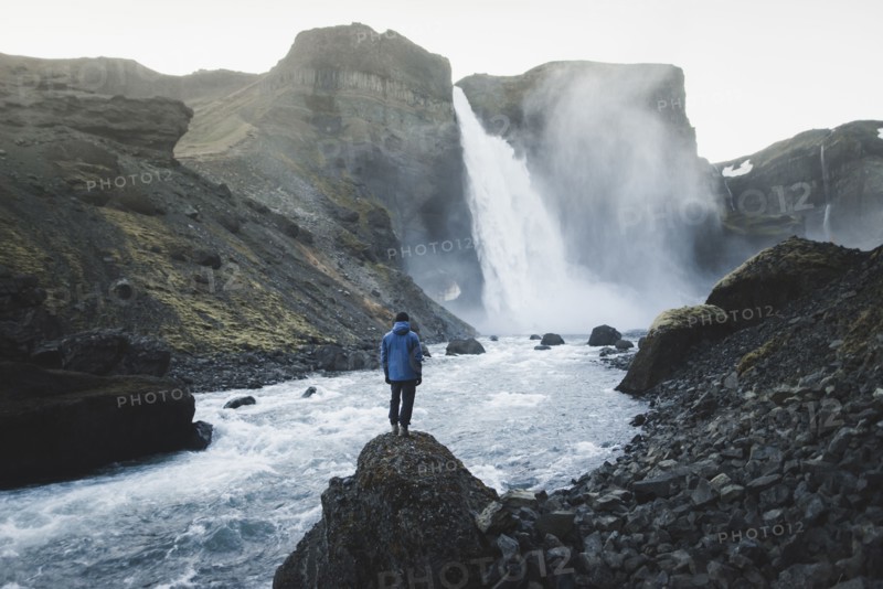 Hiker by Haifoss waterfall in Iceland