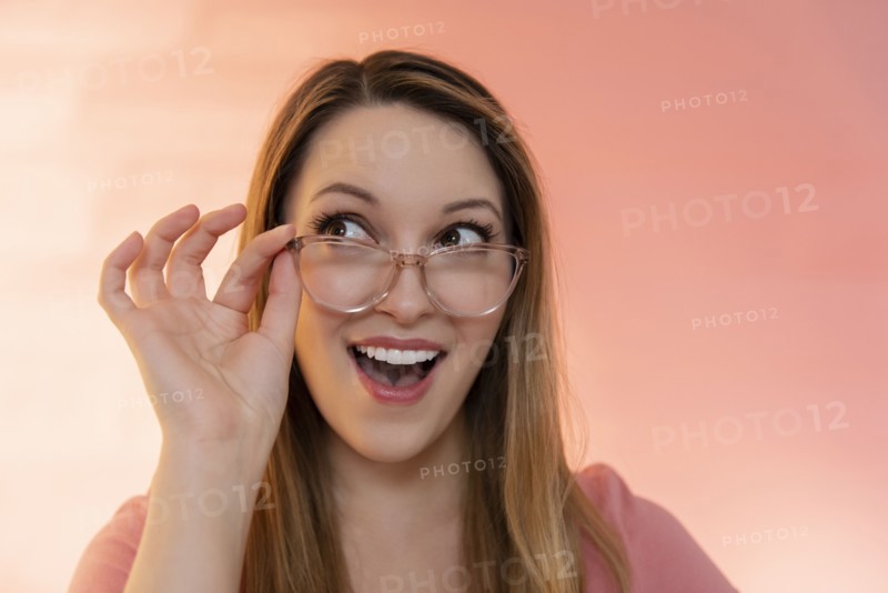 Excited young woman wearing glasses