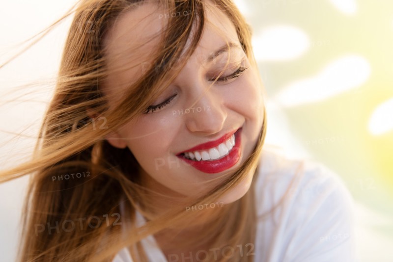 Portrait of windswept young woman wearing red lipstick