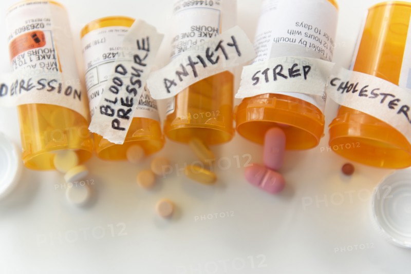 Spilled pill bottles labelled with ailments