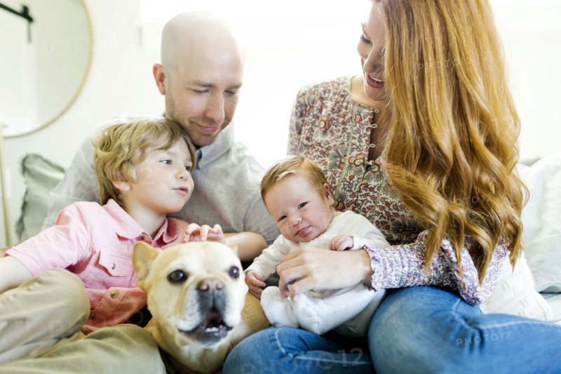 Family and their dog on bed