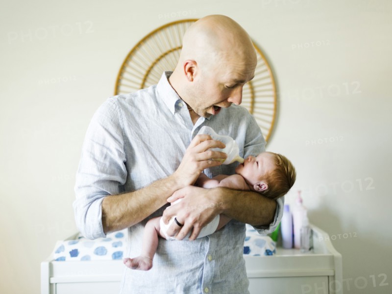 Man feeding his baby son