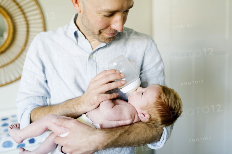 Man feeding his baby son