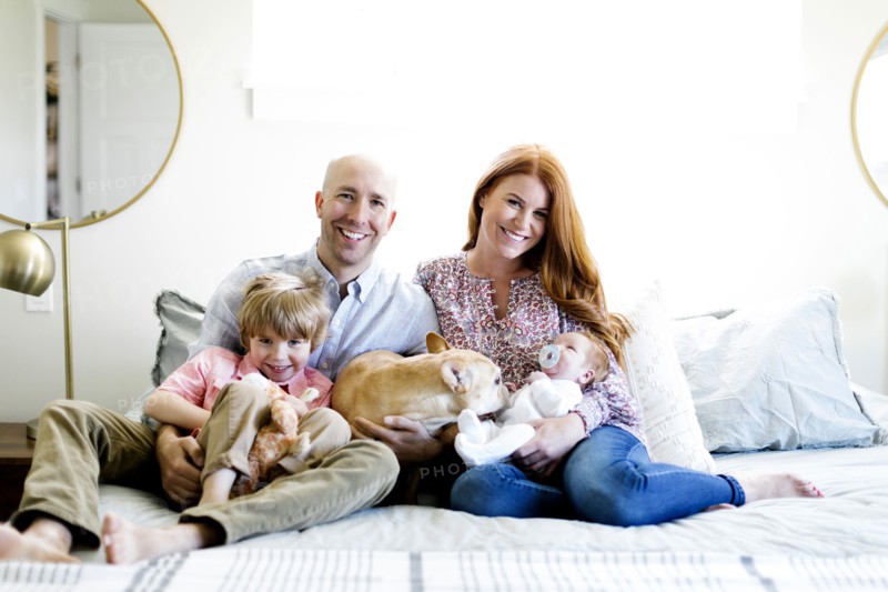 Family and their dog on bed
