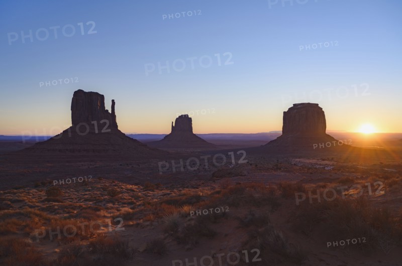Silhouettes of rock formations at sunset in Monument Valley, Arizona, USA