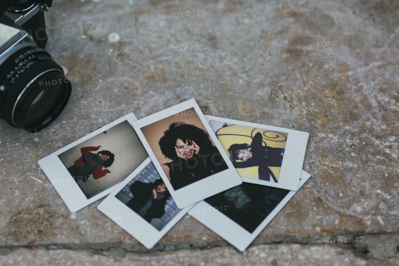 Polaroid photographs of young woman by camera