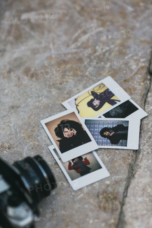 Polaroid photographs of young woman by camera
