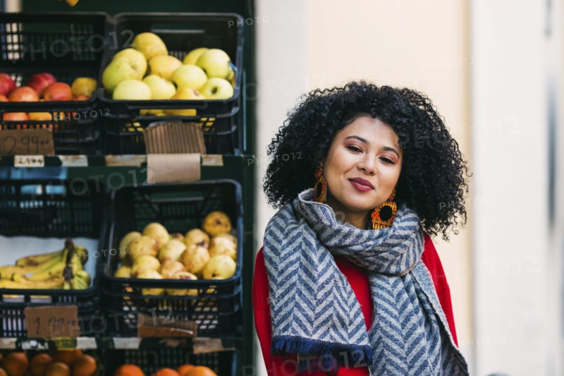 Young woman by crates of fruit