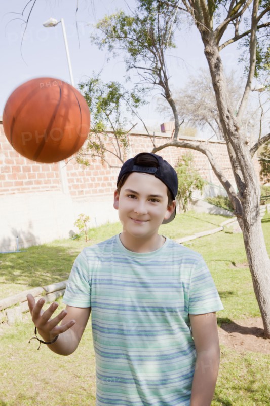 Teenage boy throwing basketball