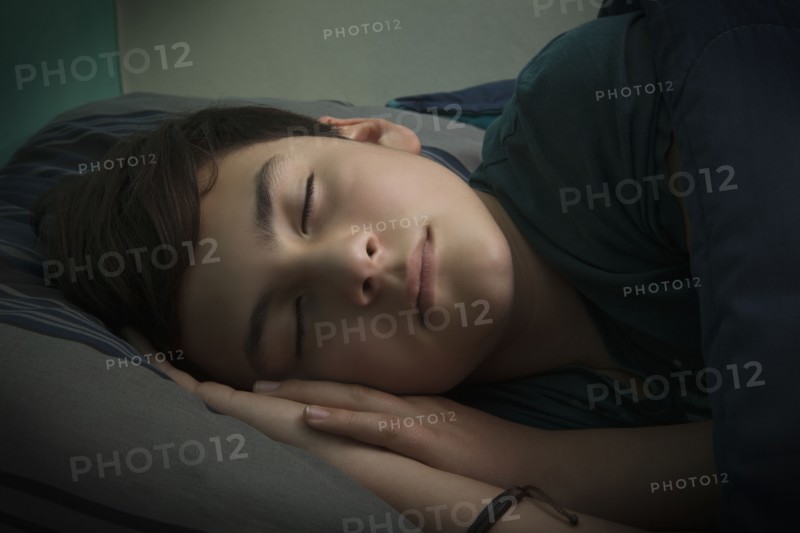 Boy sleeping in bed