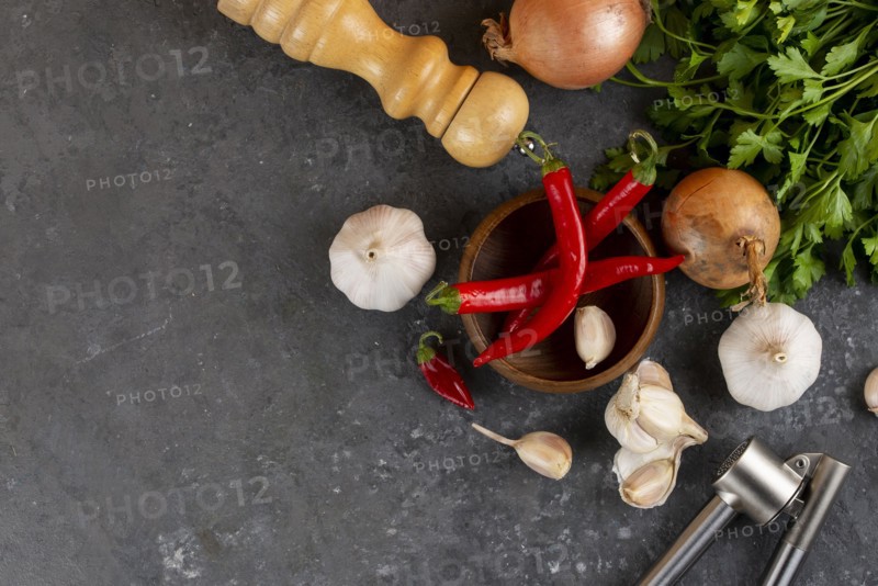 Chili peppers with garlic, onion and pepper mill