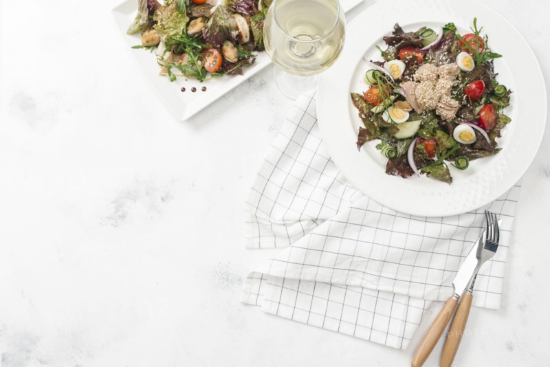 Plate of salad with white wine