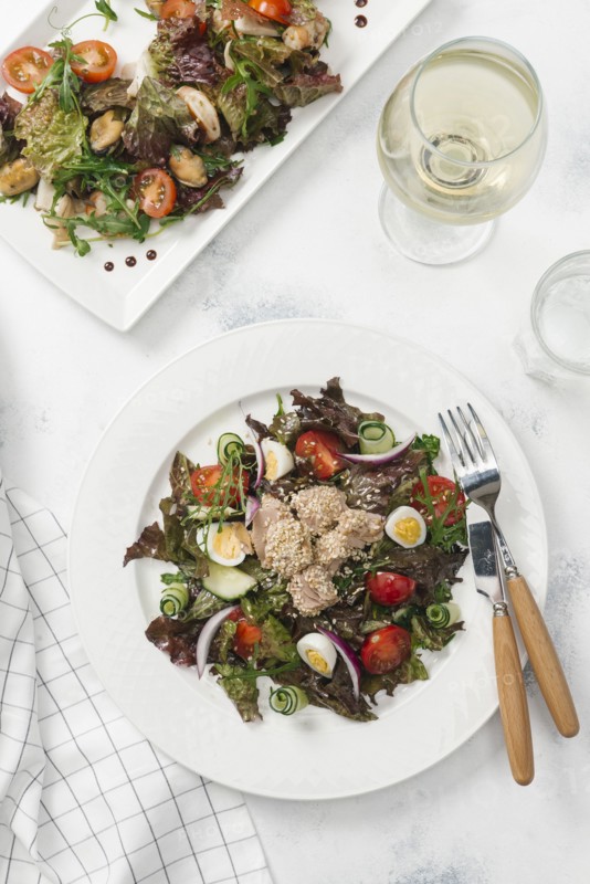 Plate of salad with white wine