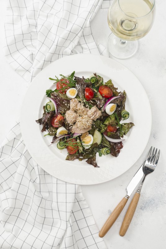 Plate of salad with white wine