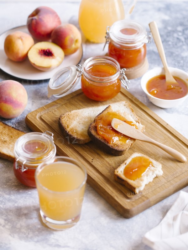 Apricot jam on toast with peaches and juice