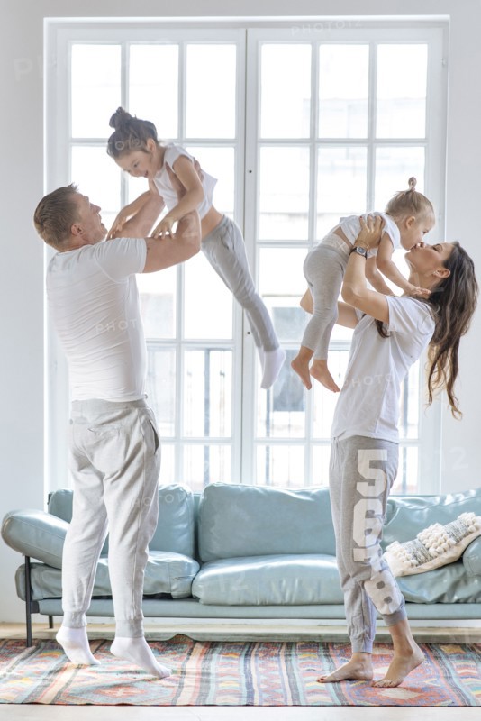 Parent lifting daughters by window