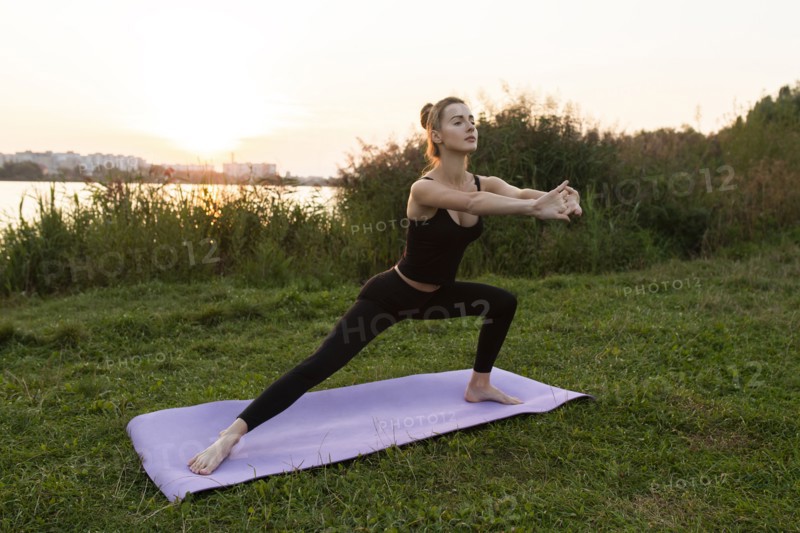 Young woman practicing yoga in park