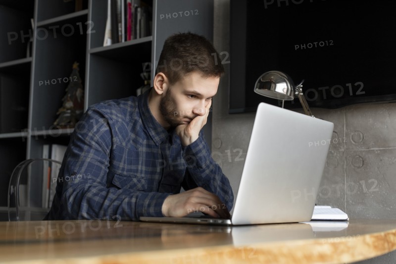 Young businessman looking at laptop