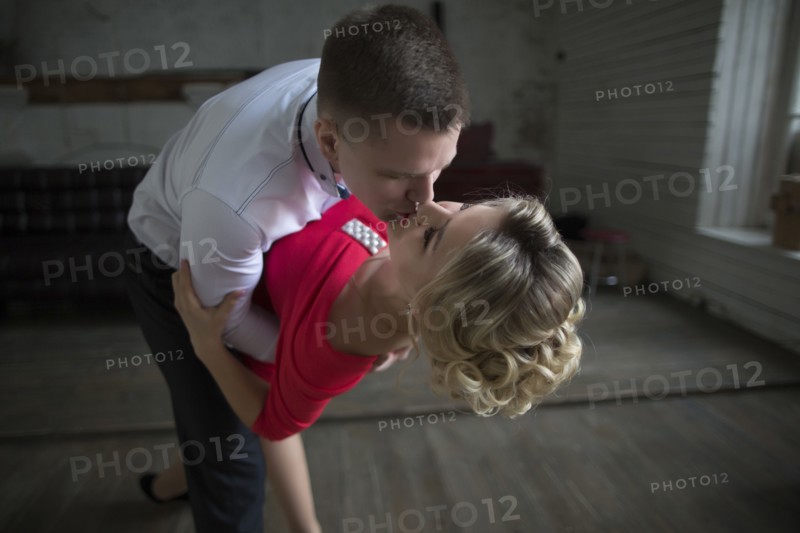 Man dipping and kissing woman