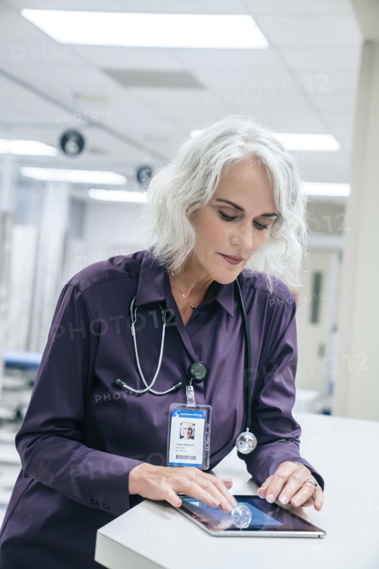 Doctor using digital tablet in hospital