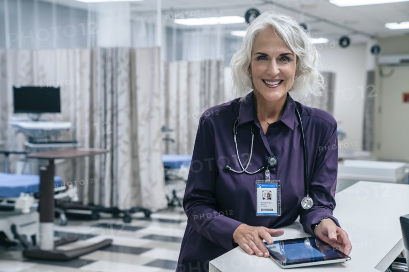 Smiling doctor holding digital tablet in hospital