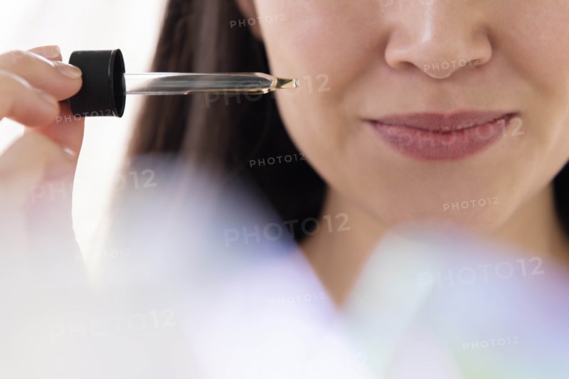 Woman with pipette of essential oil