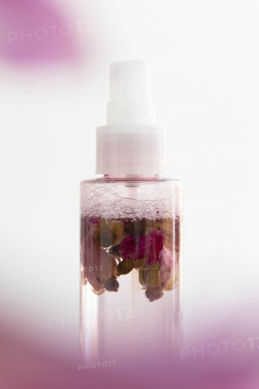 Skin care spray bottle with flowers inside