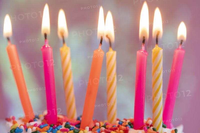 Lit candles on birthday cake