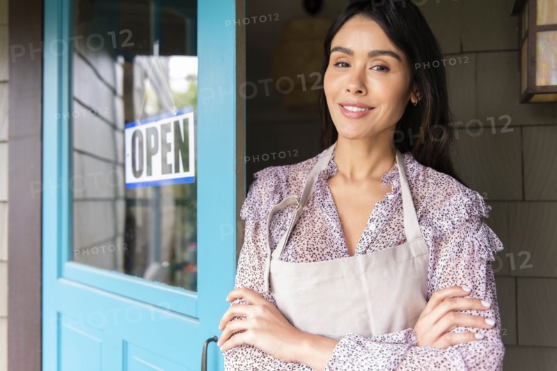 Woman by door to shop with open sign