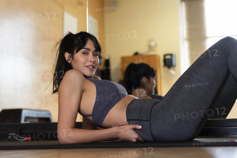 Woman lying on yoga mat