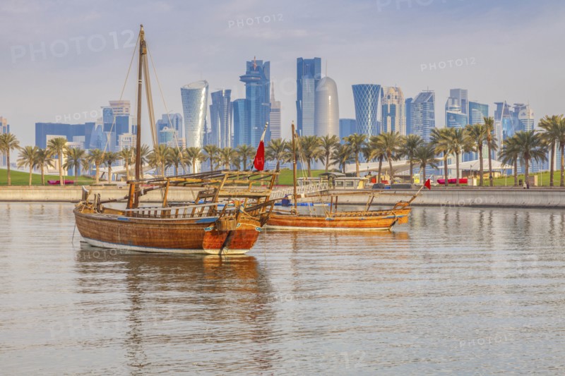 Boats by skyscraper skyline in Doha, Qatar