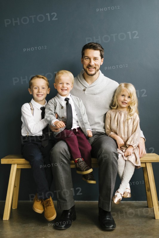 Father sitting with his three children
