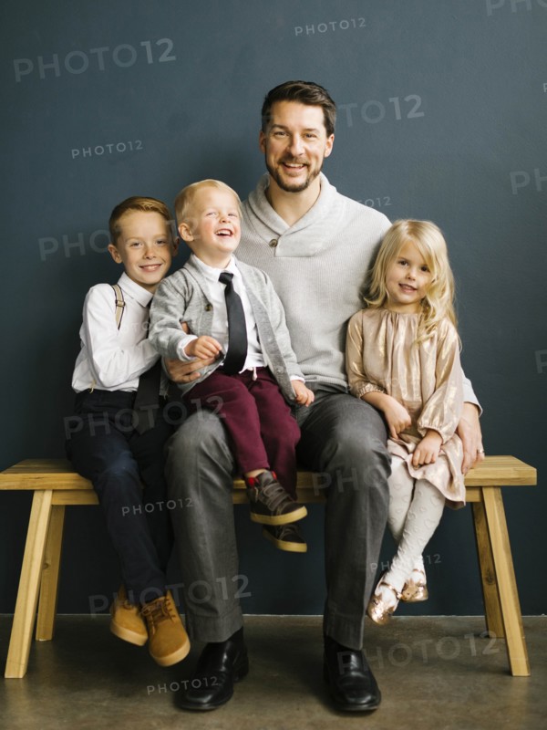 Father sitting with his three children