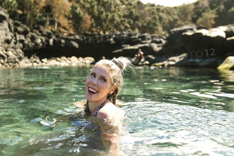 Smiling woman swimming in sea