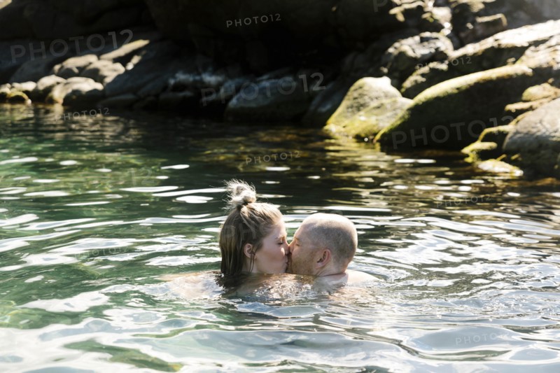 Couple kiss while swimming in sea