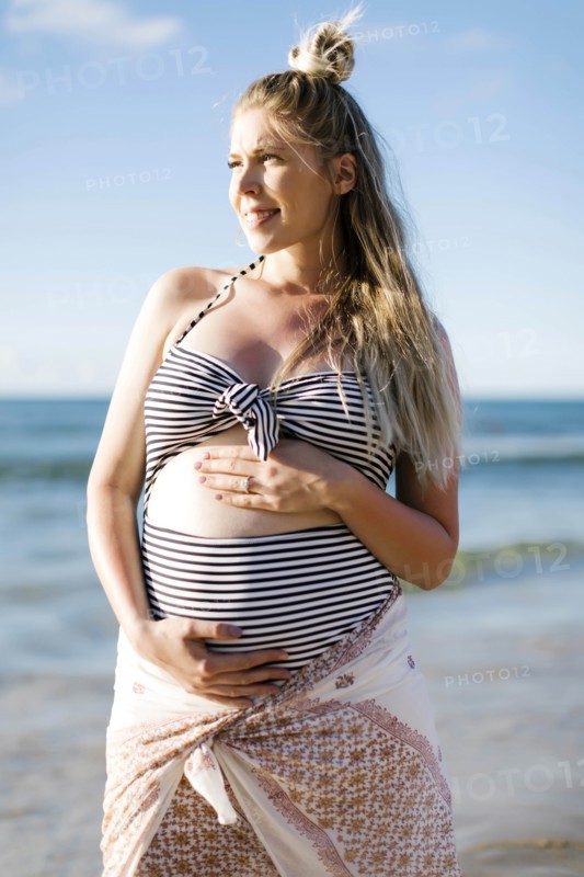 Pregnant woman on beach