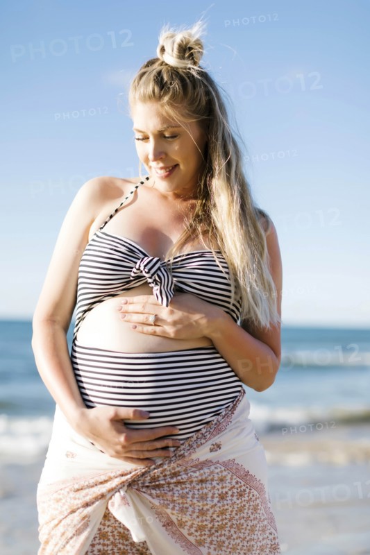 Pregnant woman on beach