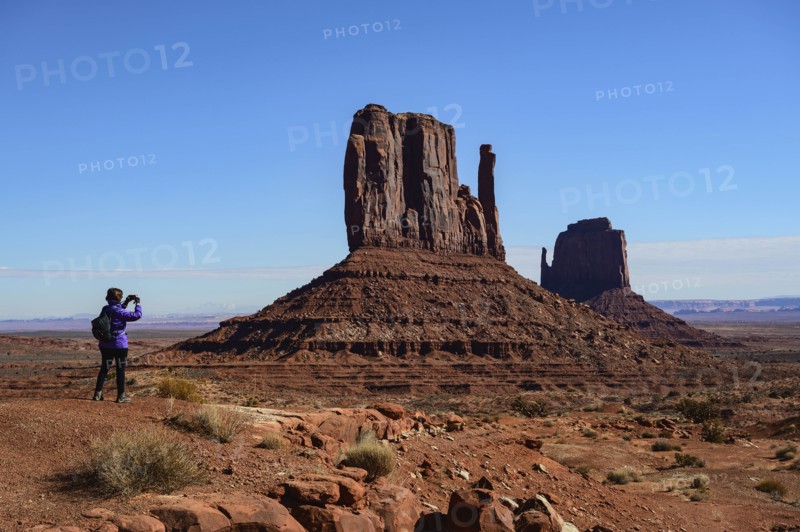 Woman photographing butte in Monument Valley, Arizona, USA
