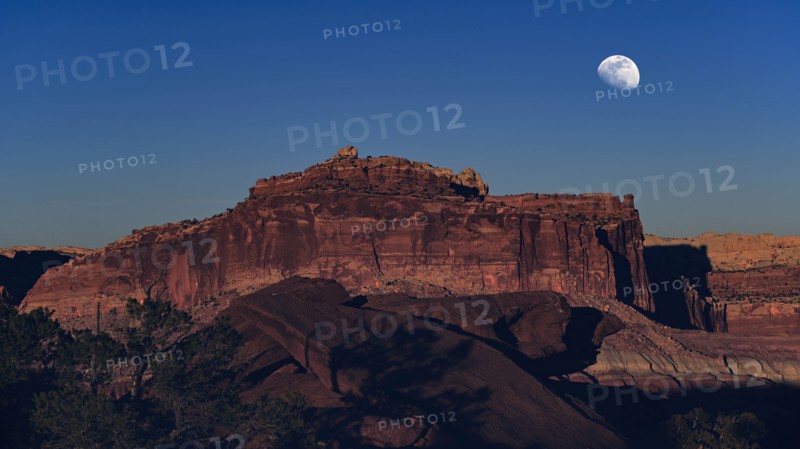 Moon over rock formation in Capitol Reef National Park, USA