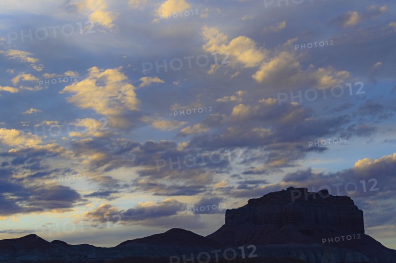 Silhouette of rock formations under clouds at sunset in Goblin Valley State Park, Utah, USA