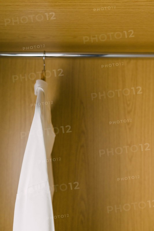 Shirts on clothes hangers in wardrobe
