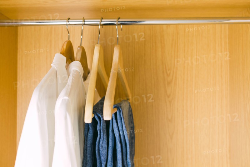 Clothes hanging in wardrobe